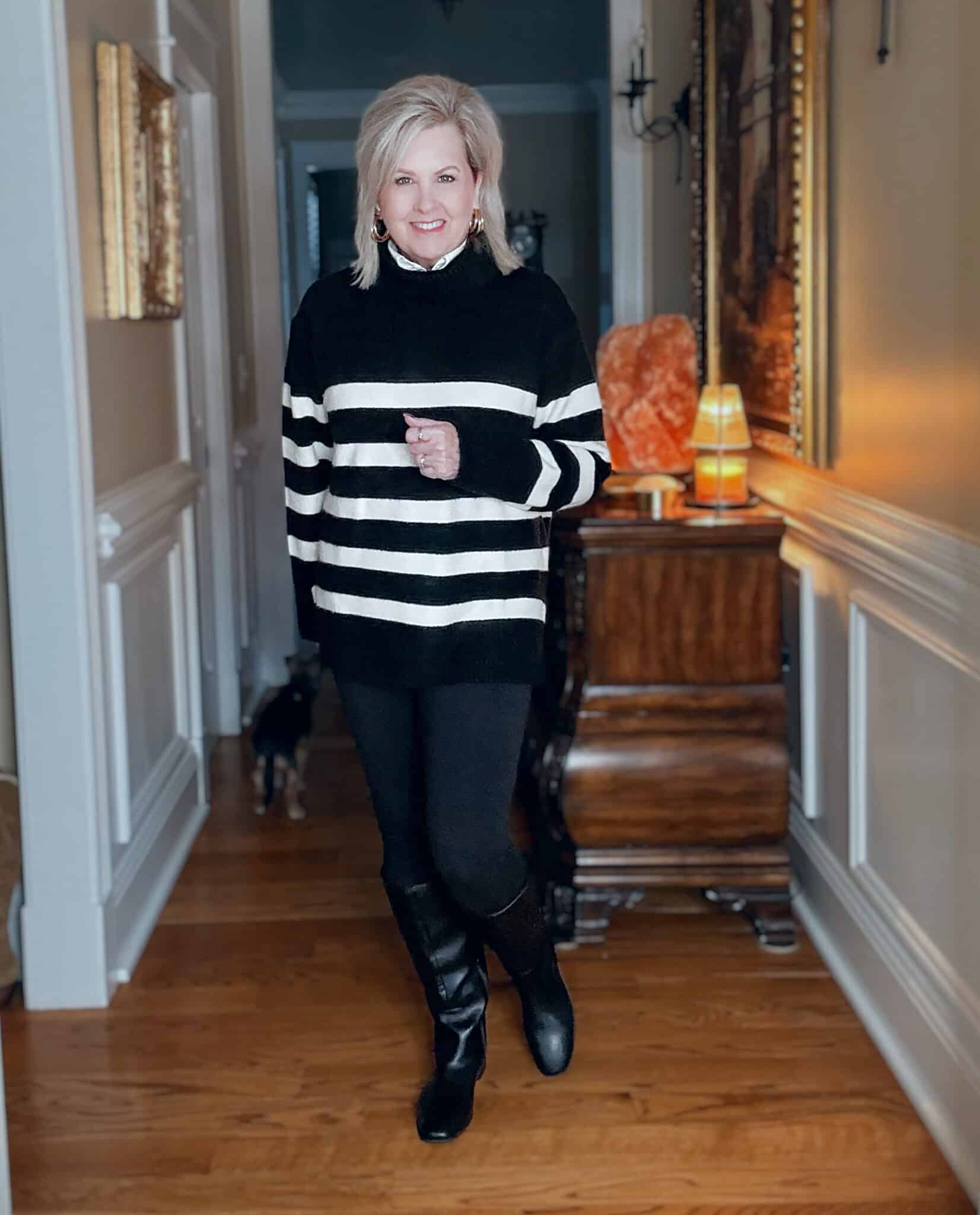 Tania wearing a black and white striped sweater with black leggings and riding boots from Kohl's