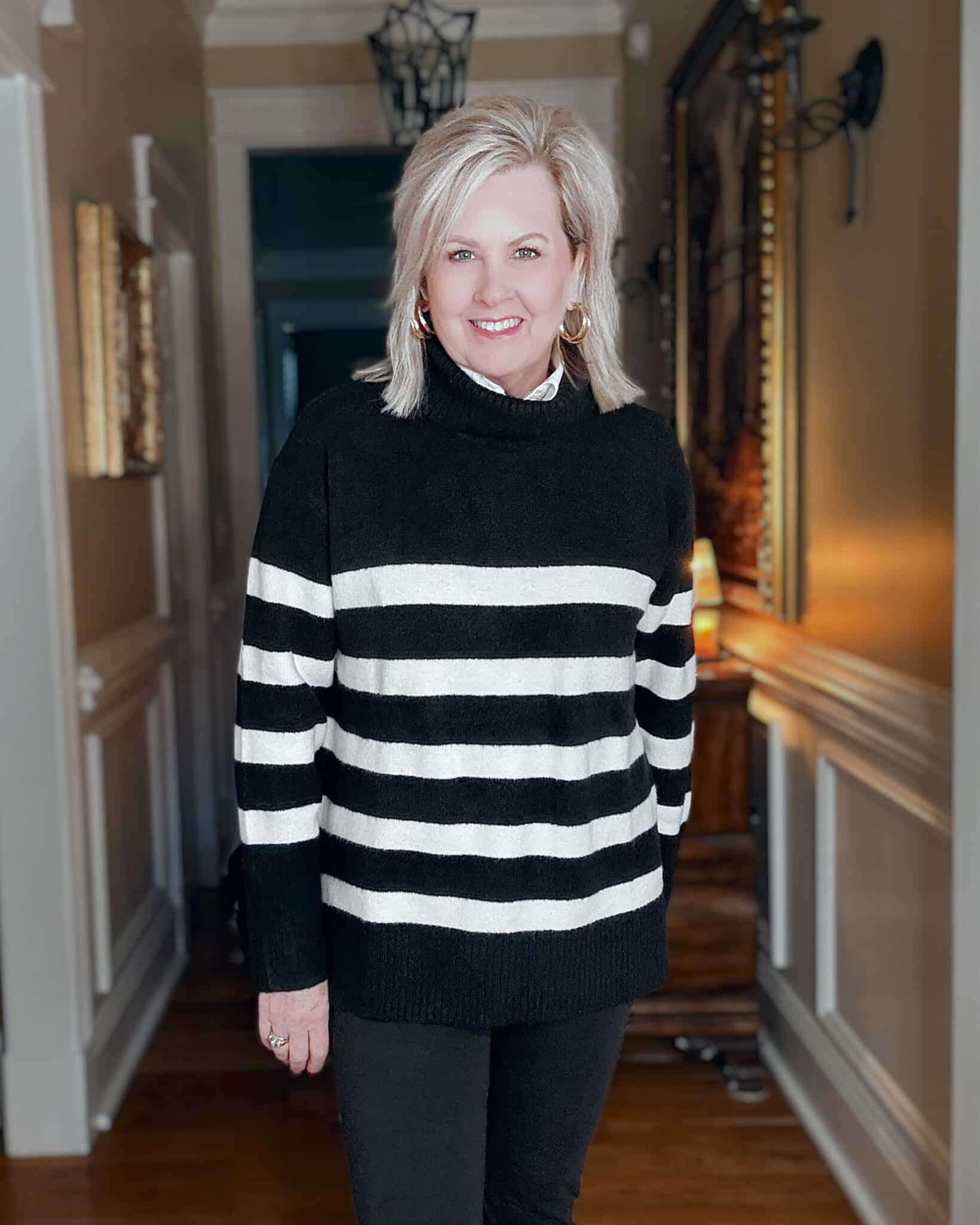 Tania wearing a black and white striped sweater  from Kohl's
