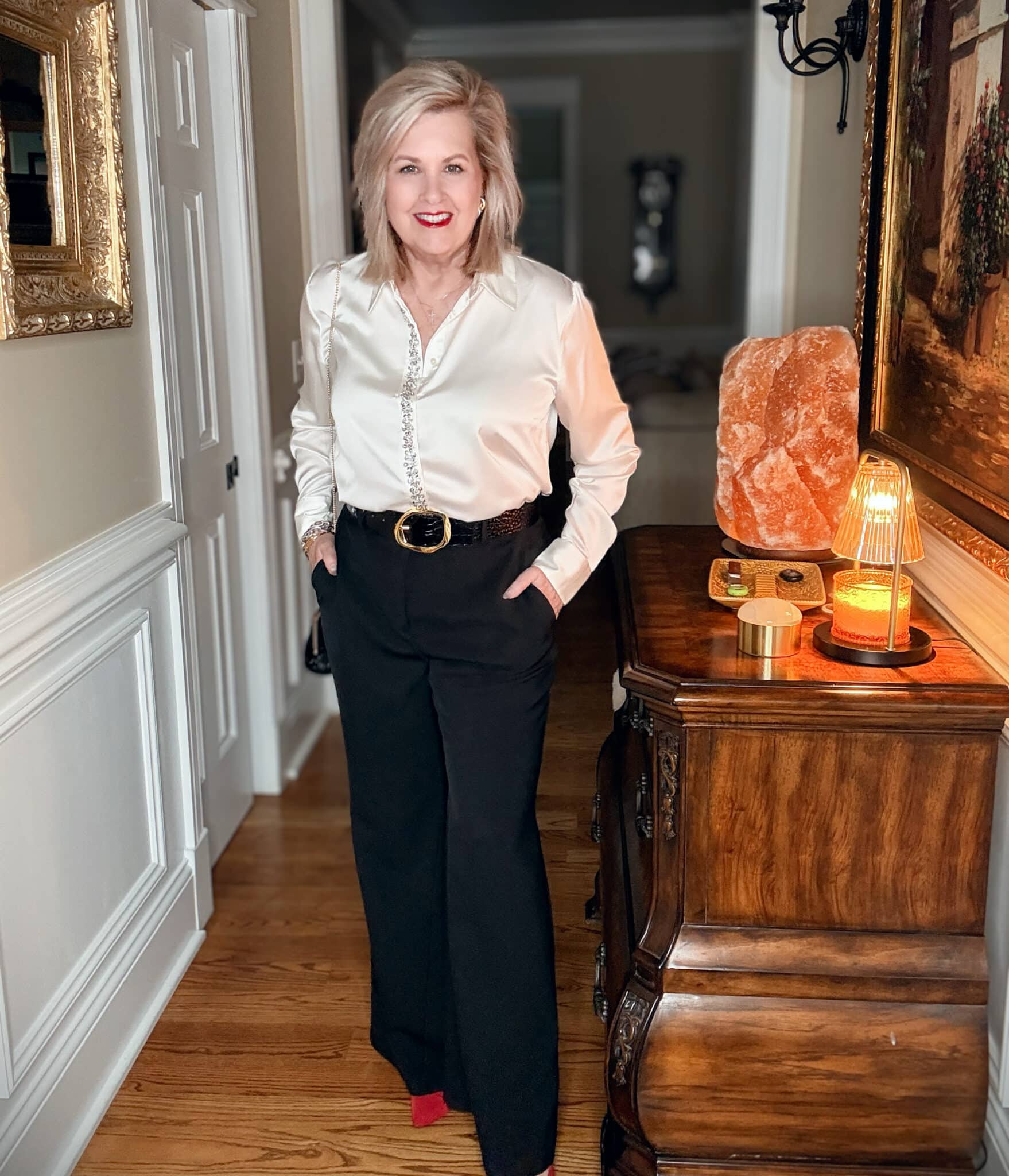 Tania wearing a satin embellished shirt and black pants