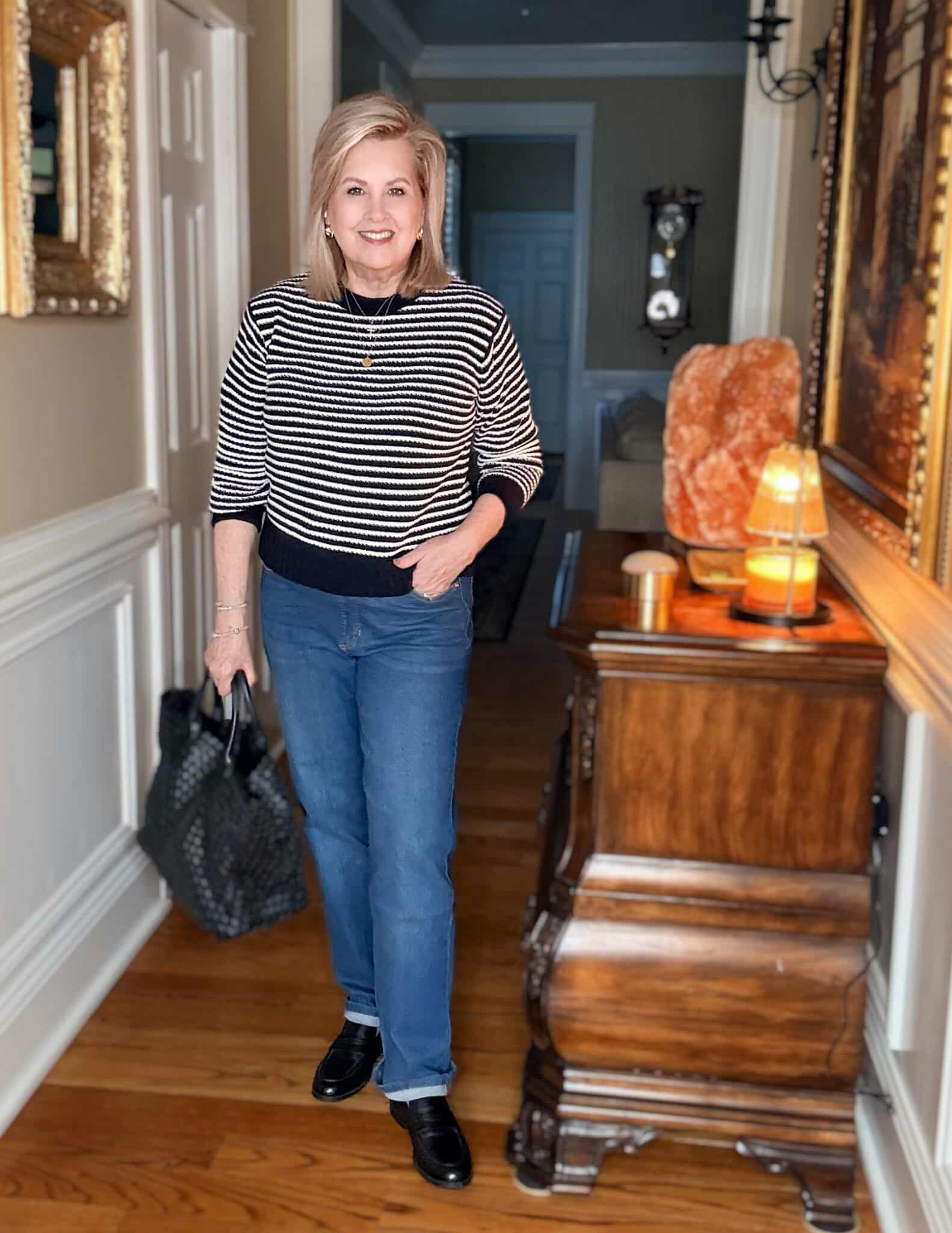 Tania wearing a navy & white striped sweater with jeans from Walmart