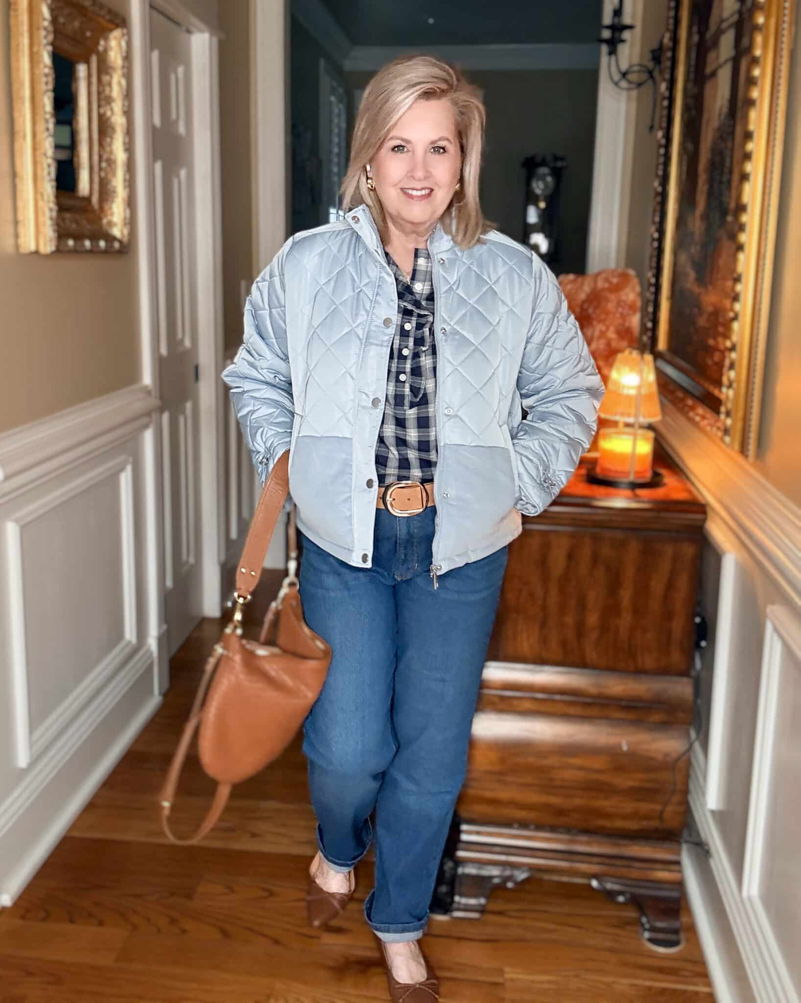 Tania wearing a light blue quilted jacket with a ruffled check top and jeans from Walmart