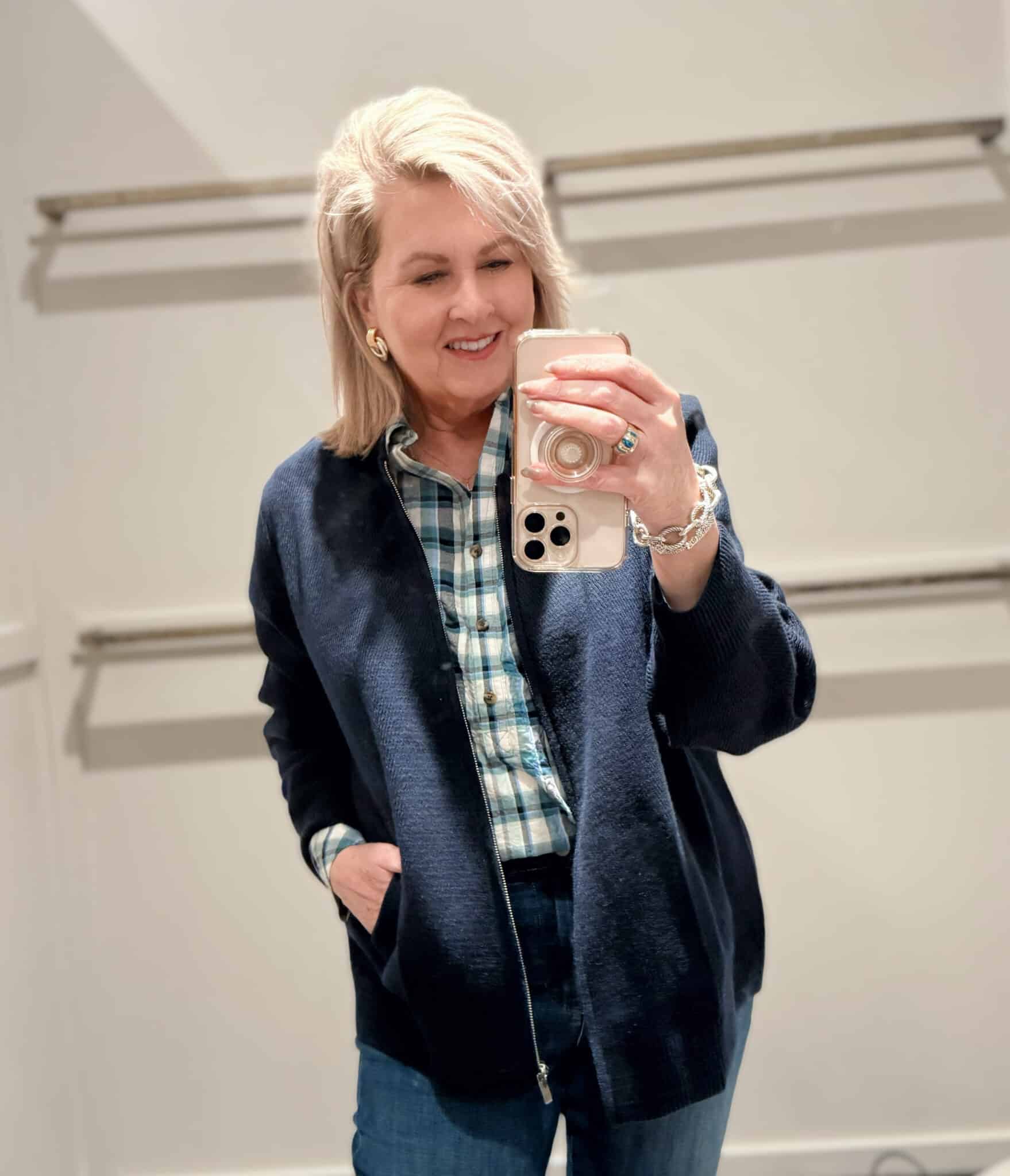 Tania wearing a checked top with a navy caridgan and flare jeans from J.Jill