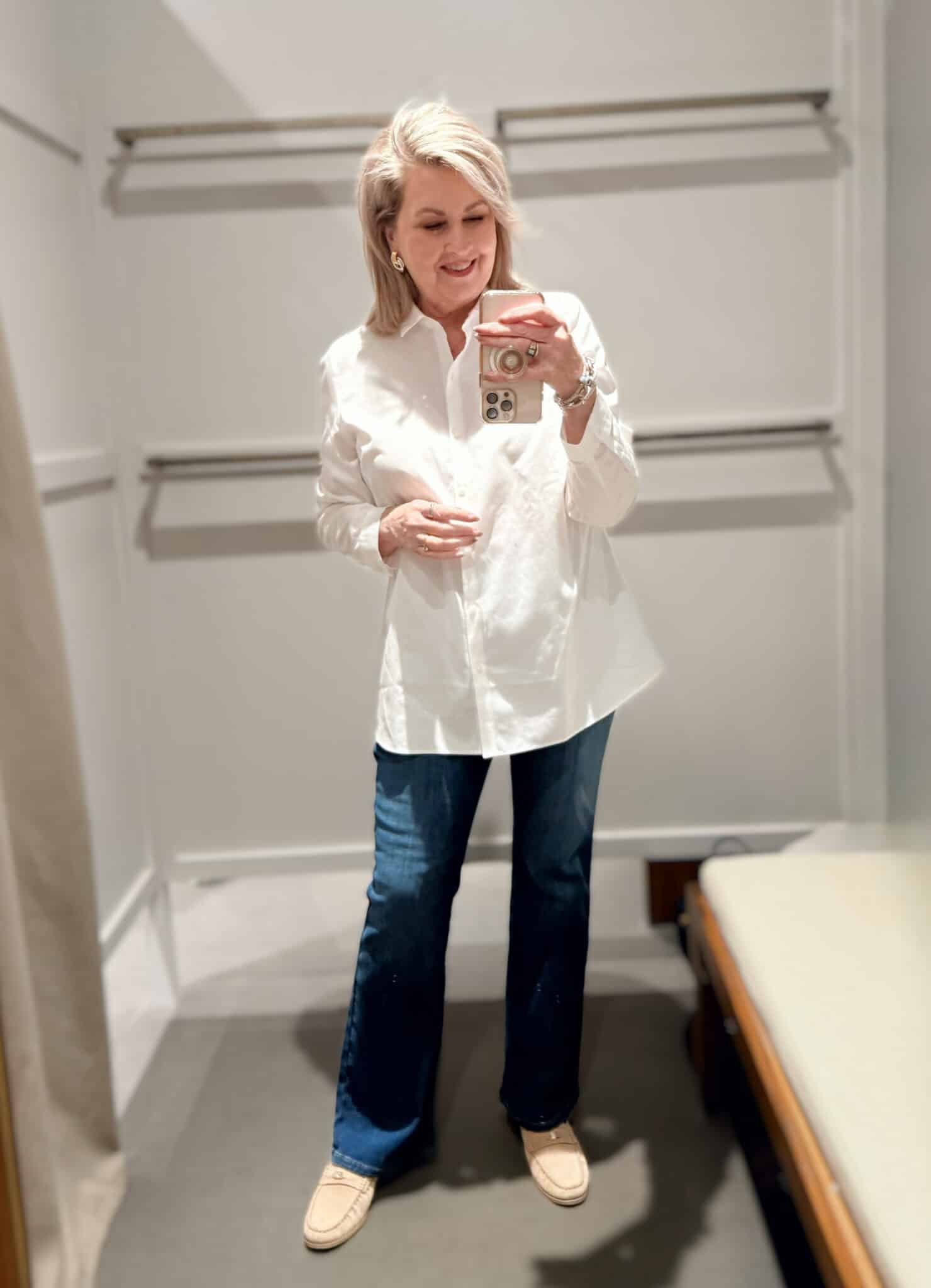 Tania wearing a white button tunic top and flare jeans from J.Jill