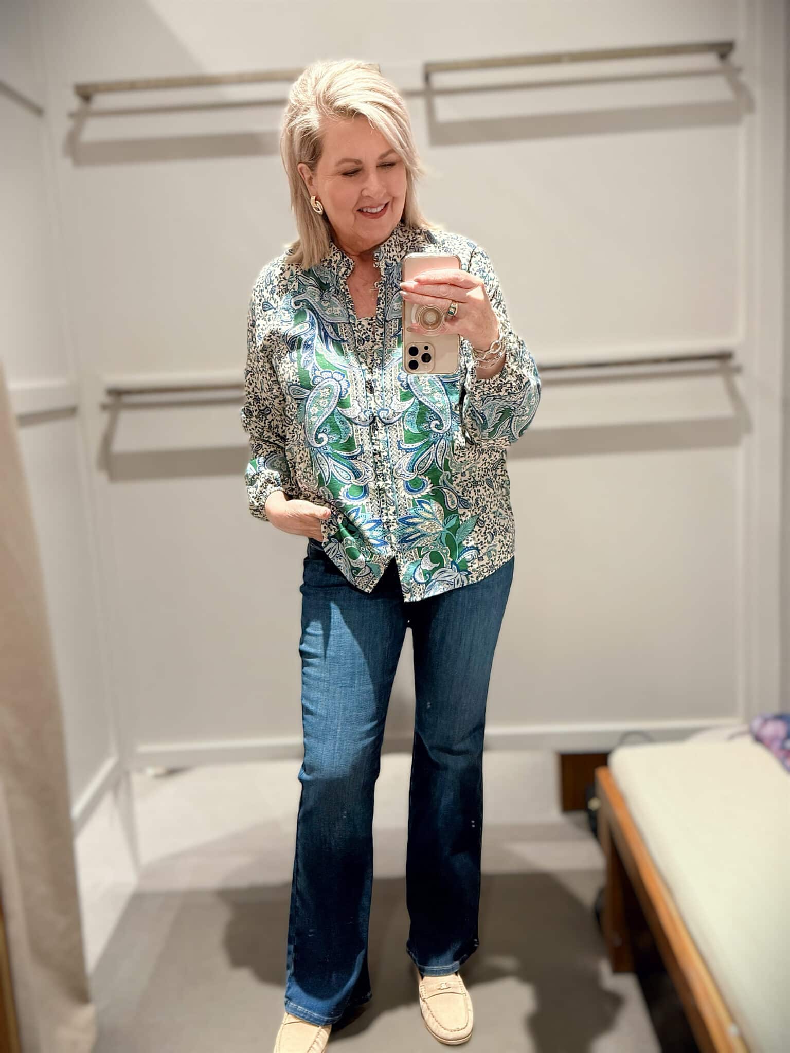 Tania wearing a brightly colored paisley top with flare jeans from J.Jill