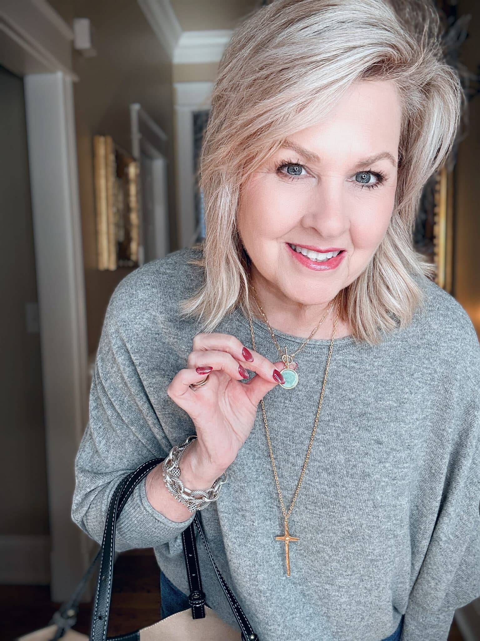 Tania wearing a gray Cashmere Sweater from Quince with a cute seafoam green necklace