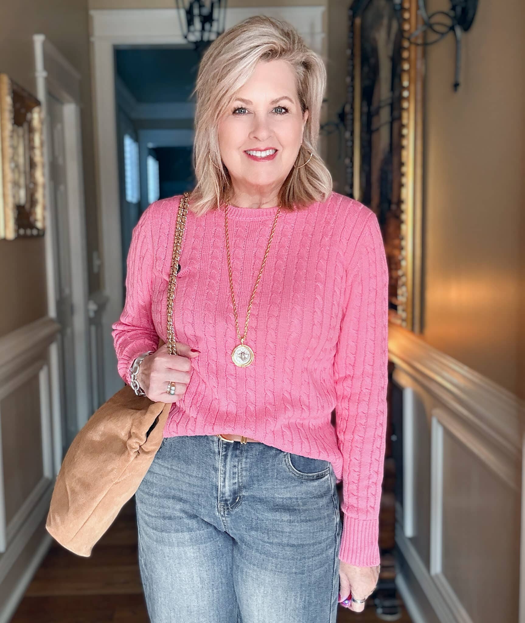 Tania wearing a pink cableknit sweater with a suede tote from Talbots