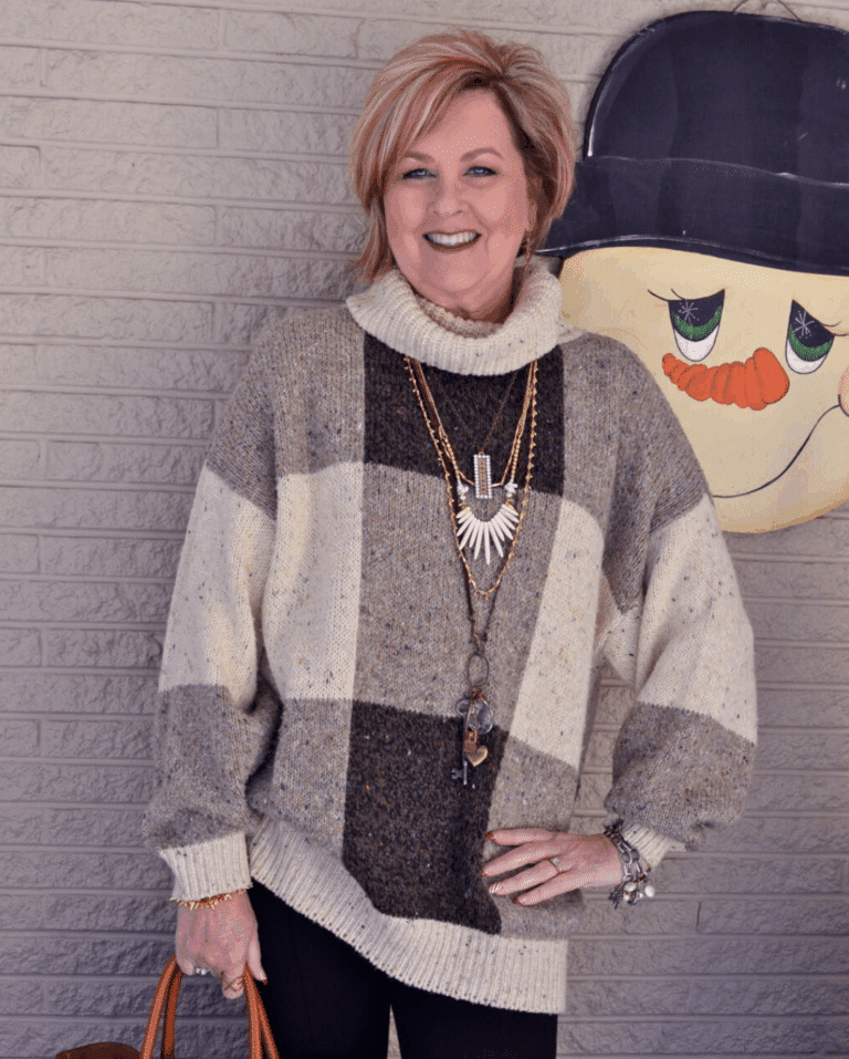 Large checked poncho in front of a snowman