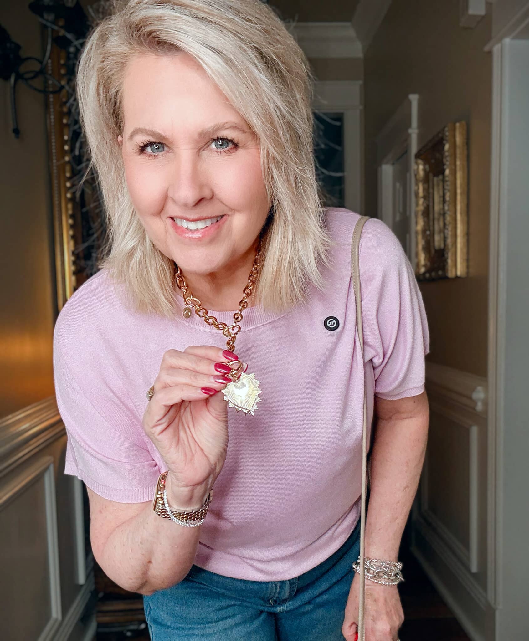 Woman wearing a light pink sweater jewelry