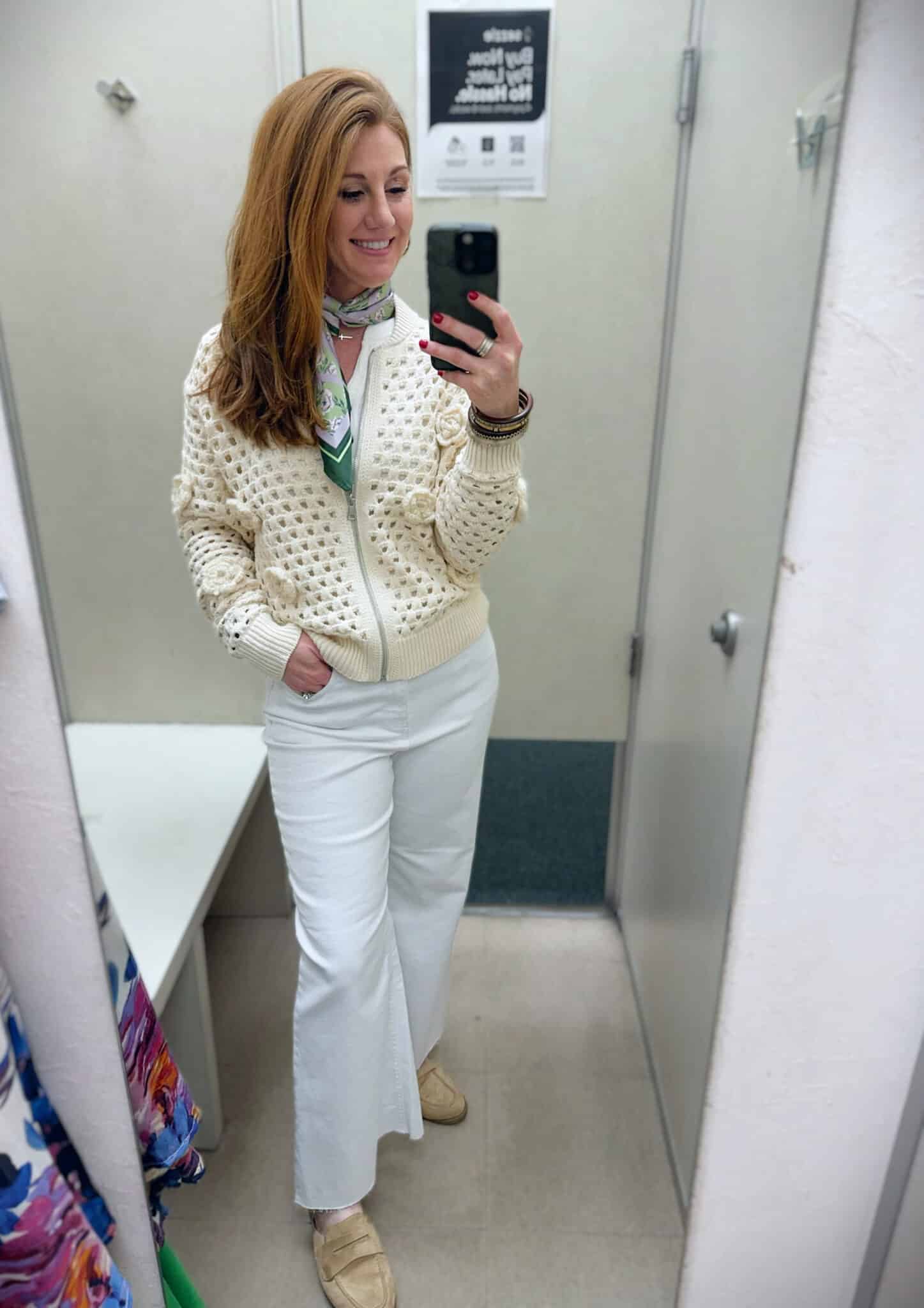 Stephanie wearing a beige cardigan with white jeans
