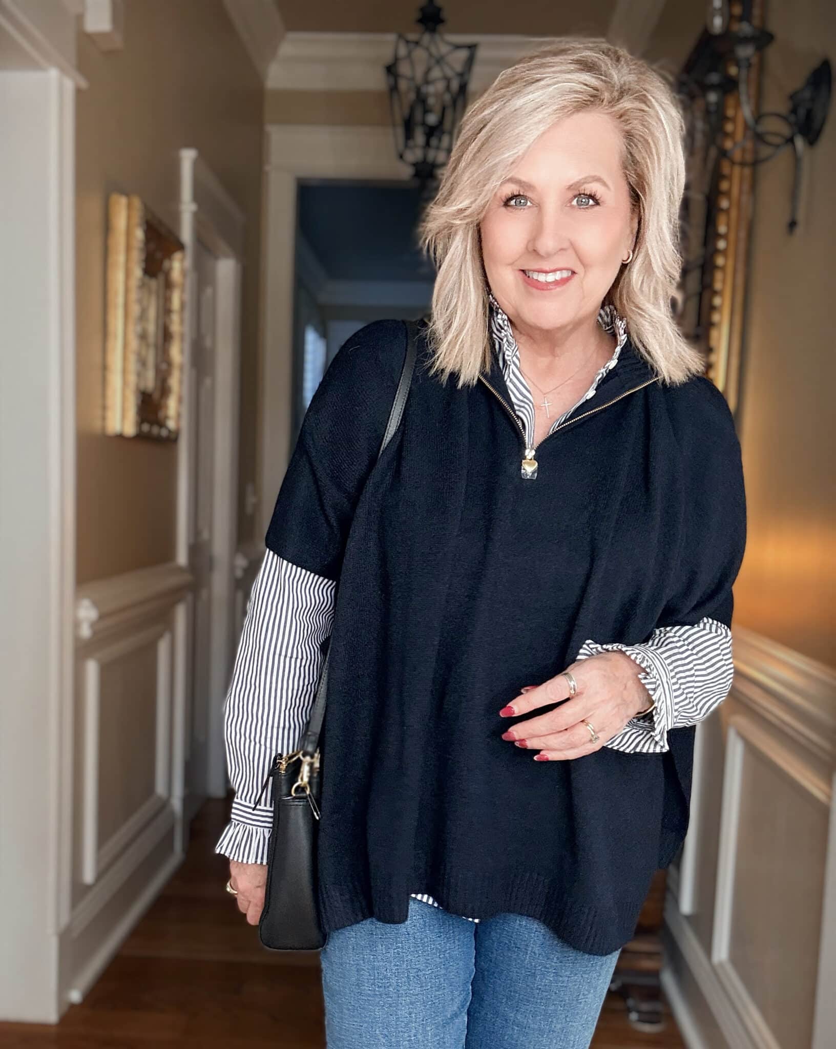 Tania wearing a striped shirt with a navy zip poncho from J.Crew Factory with jeans