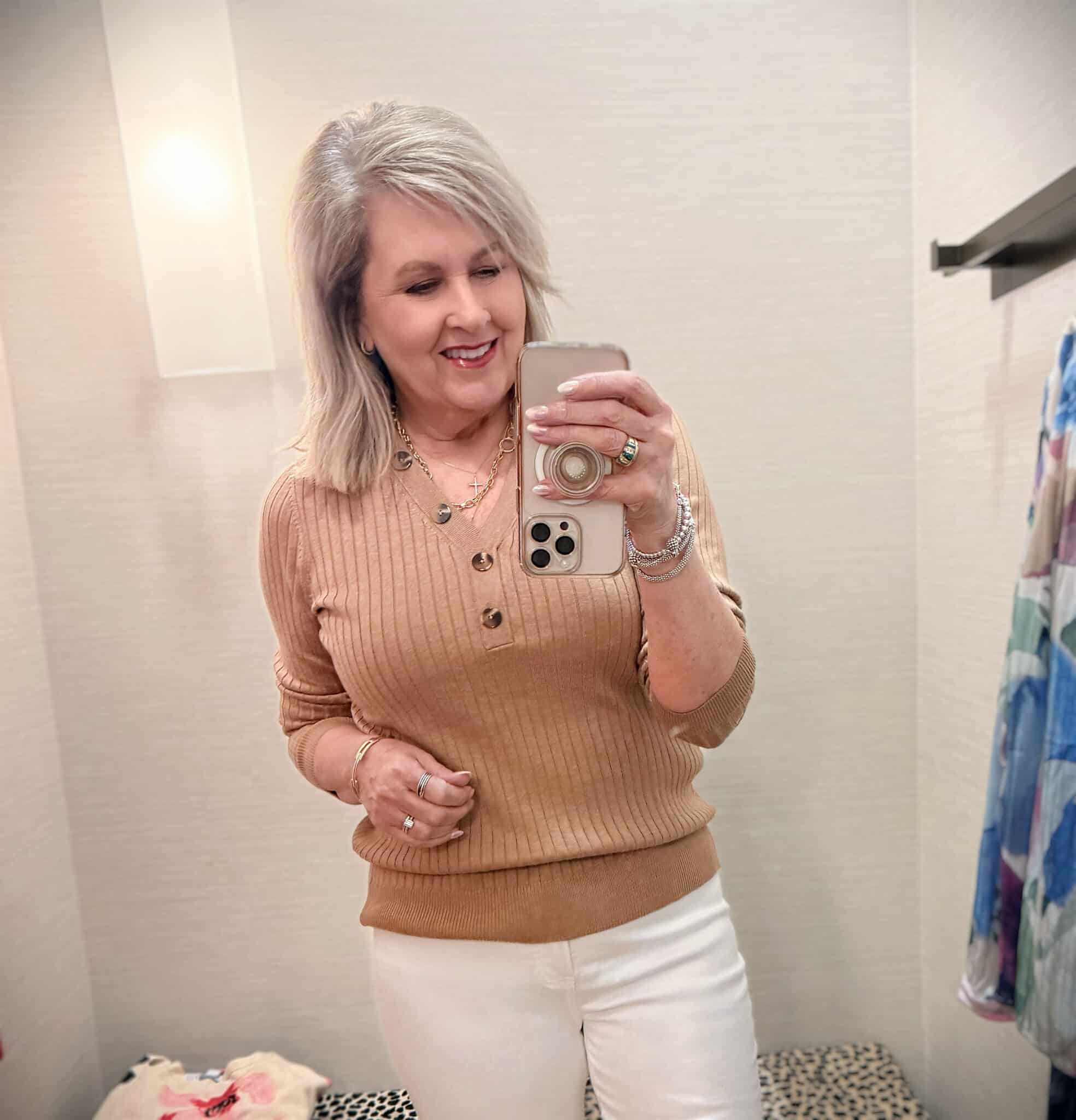 Tania wearing a beige ribbed henley from Chico's.