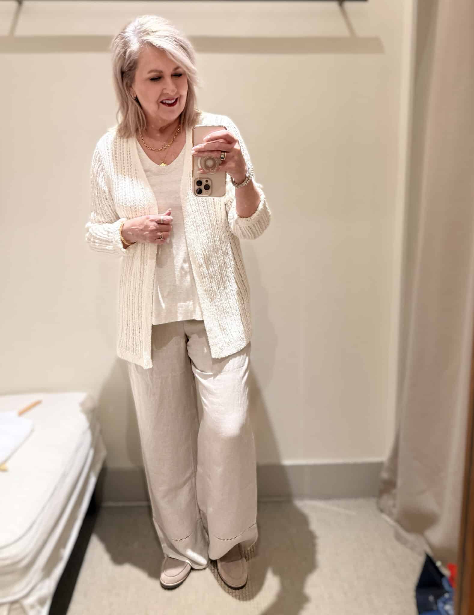 Tania wearing a cream colored cardigan over a layering tank and linen pants from J.Jill