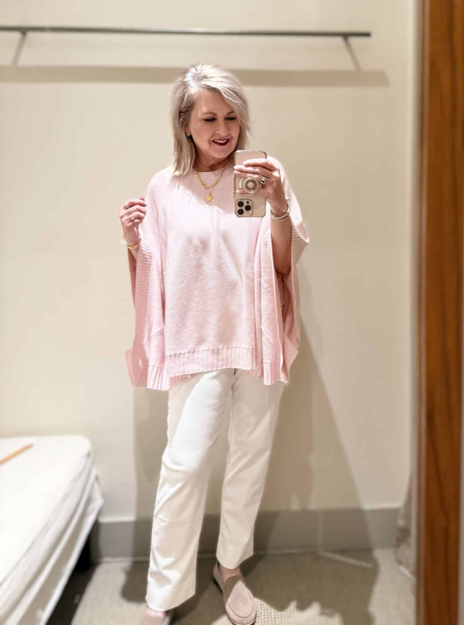 Tania wearing a pale pink poncho and white pull on pants from J.Jill