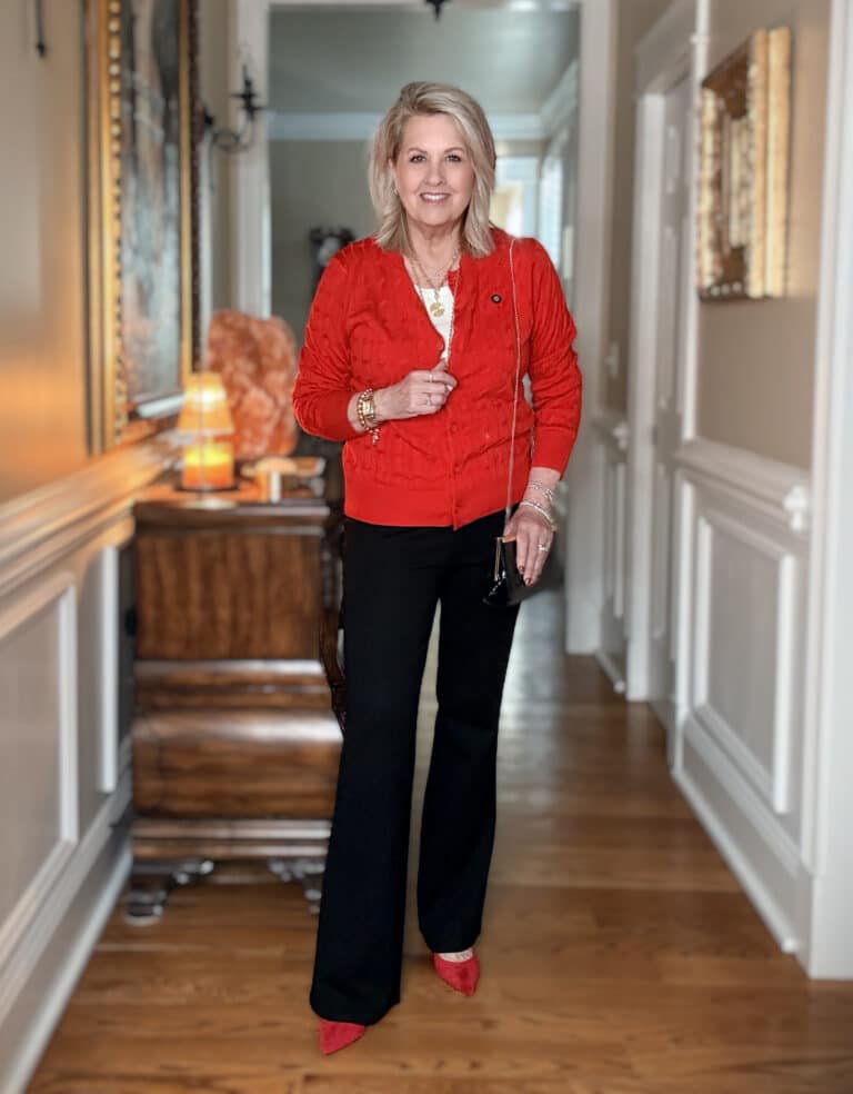 Tania wearing a red cable knit cardigan with comfortable black dress pants