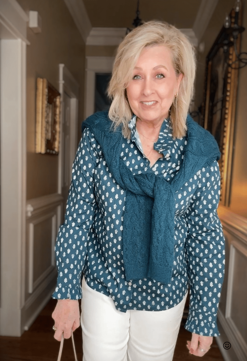 Tania wearing a teal and white shirt from J.Crew Factory with a teal sweater draped across the shoulders.