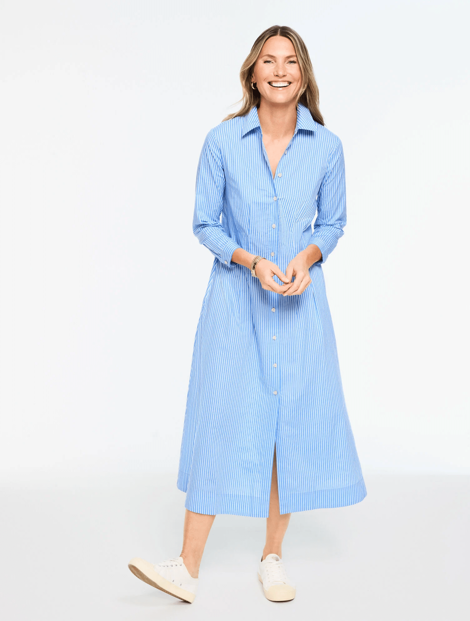 Lightweight cotton poplin shirt dress styled with white sneakers for sightseeing and comfortable travel days for women over 50