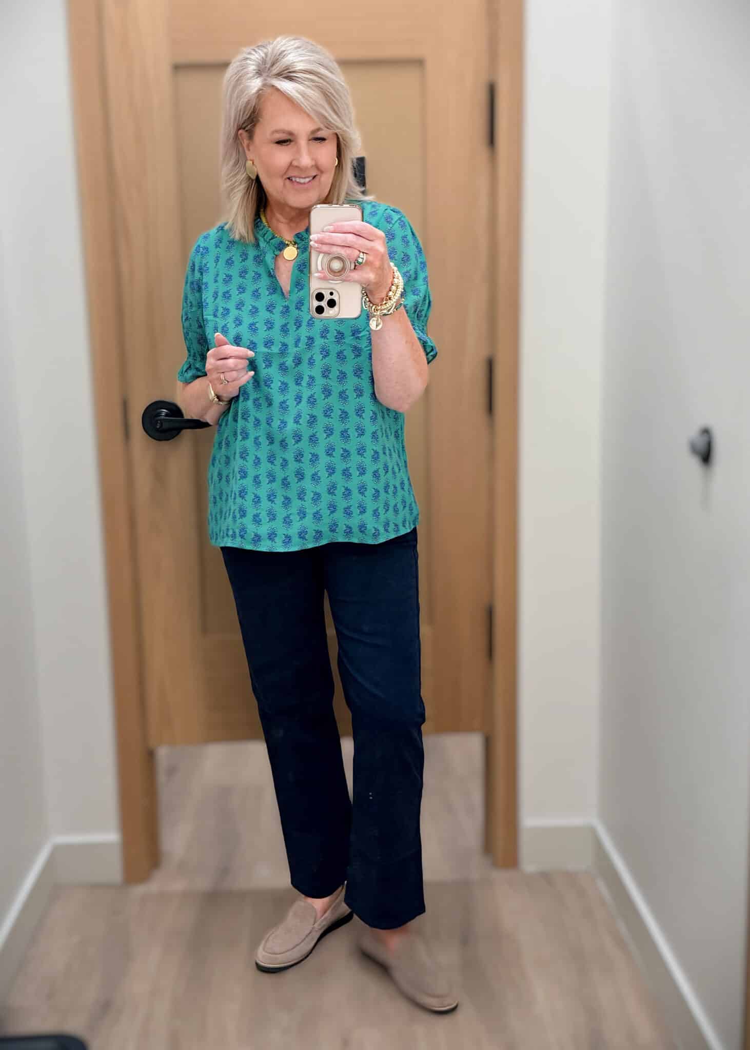 Tania wearing a green printed top untucked with dark chinos from J.Crew Factory