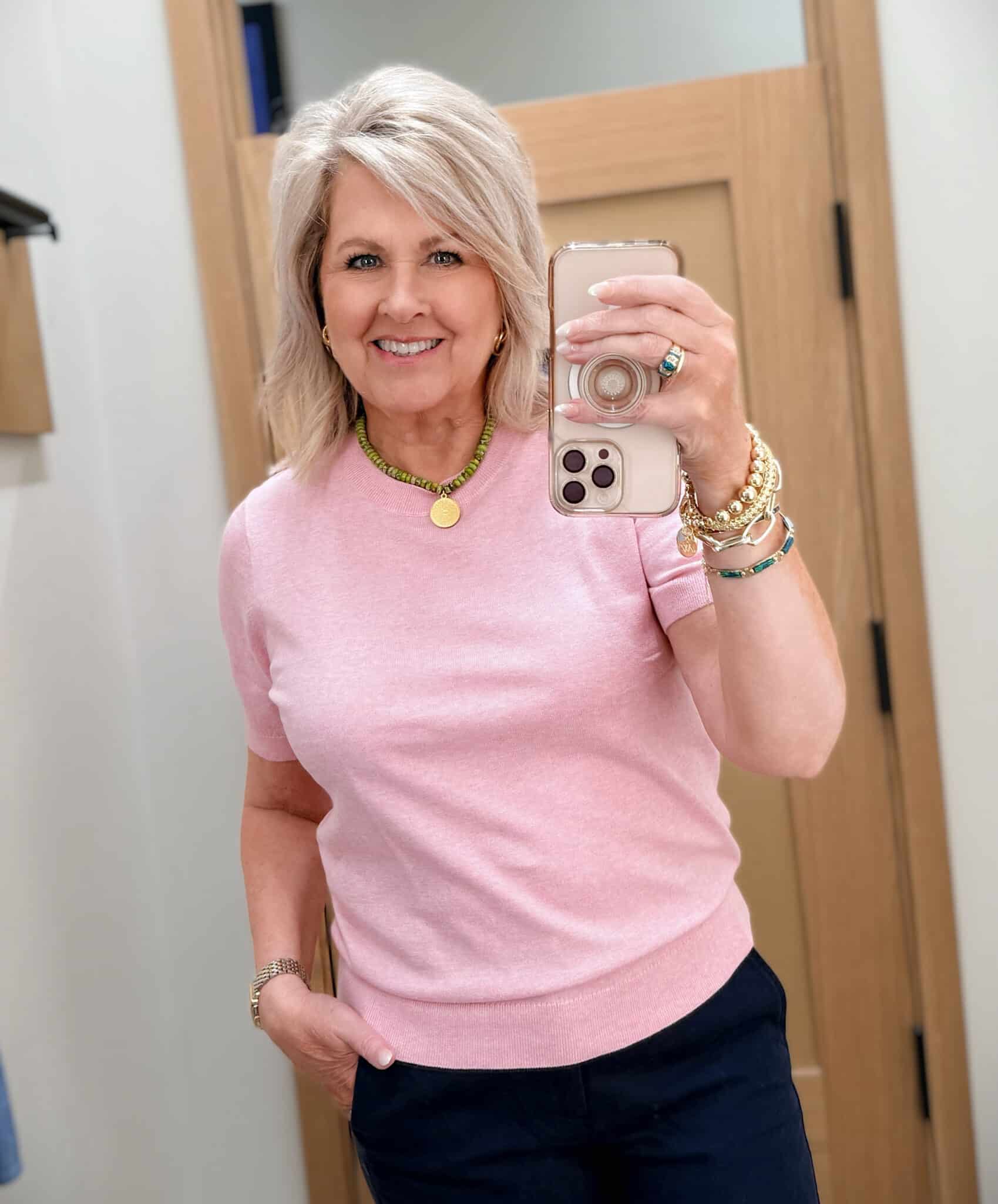 Tania wearing a pink crewneck sweater from J.Crew Factory