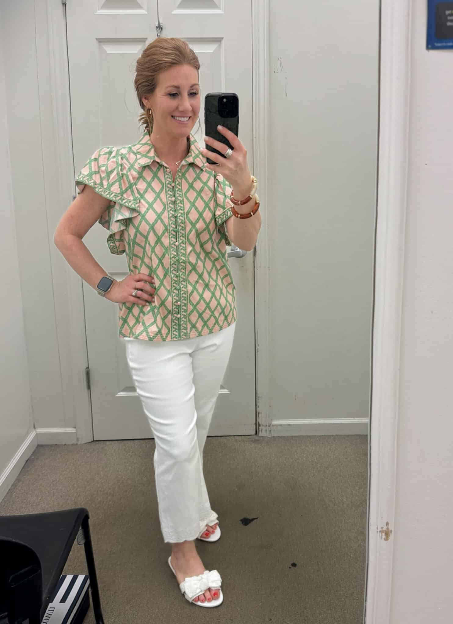 Stephanie (a petite lady) styling a green and pink plaid top with white cropped jeans and sandals from Belk