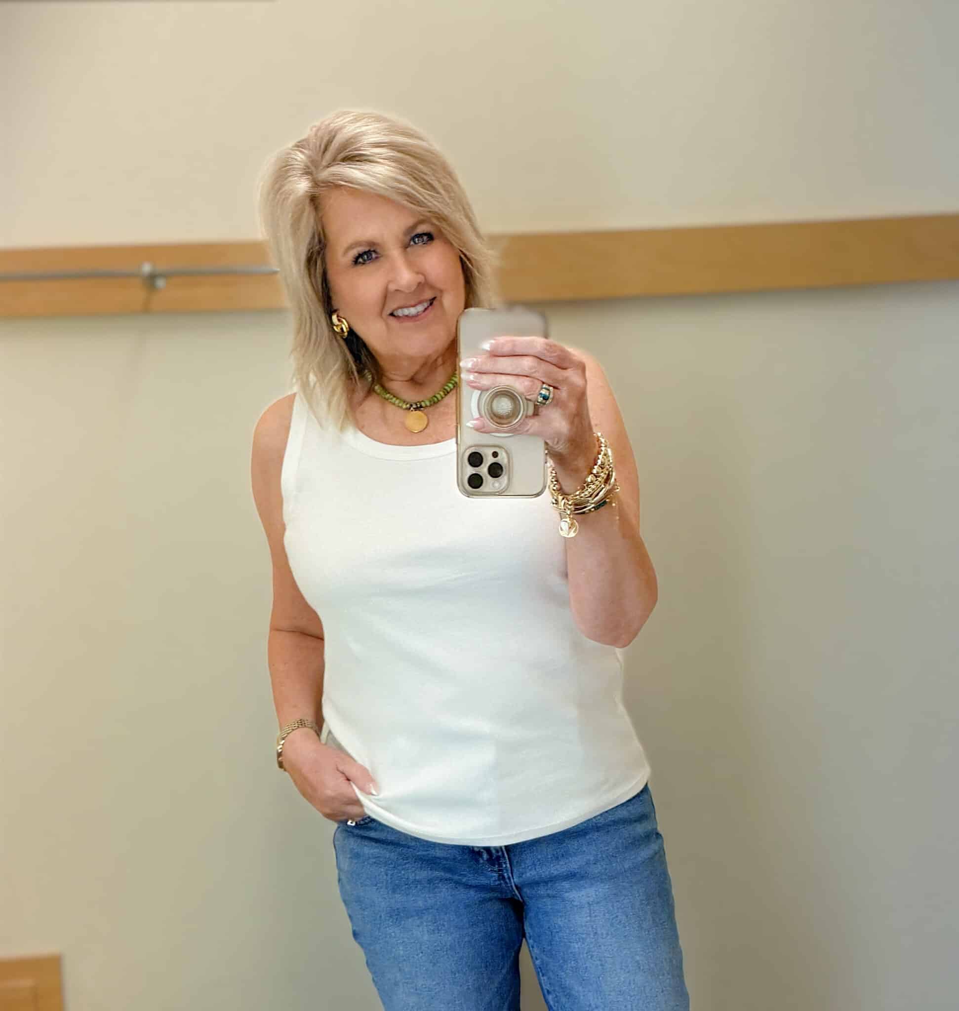 woman over 50 wearing a white tank for spring