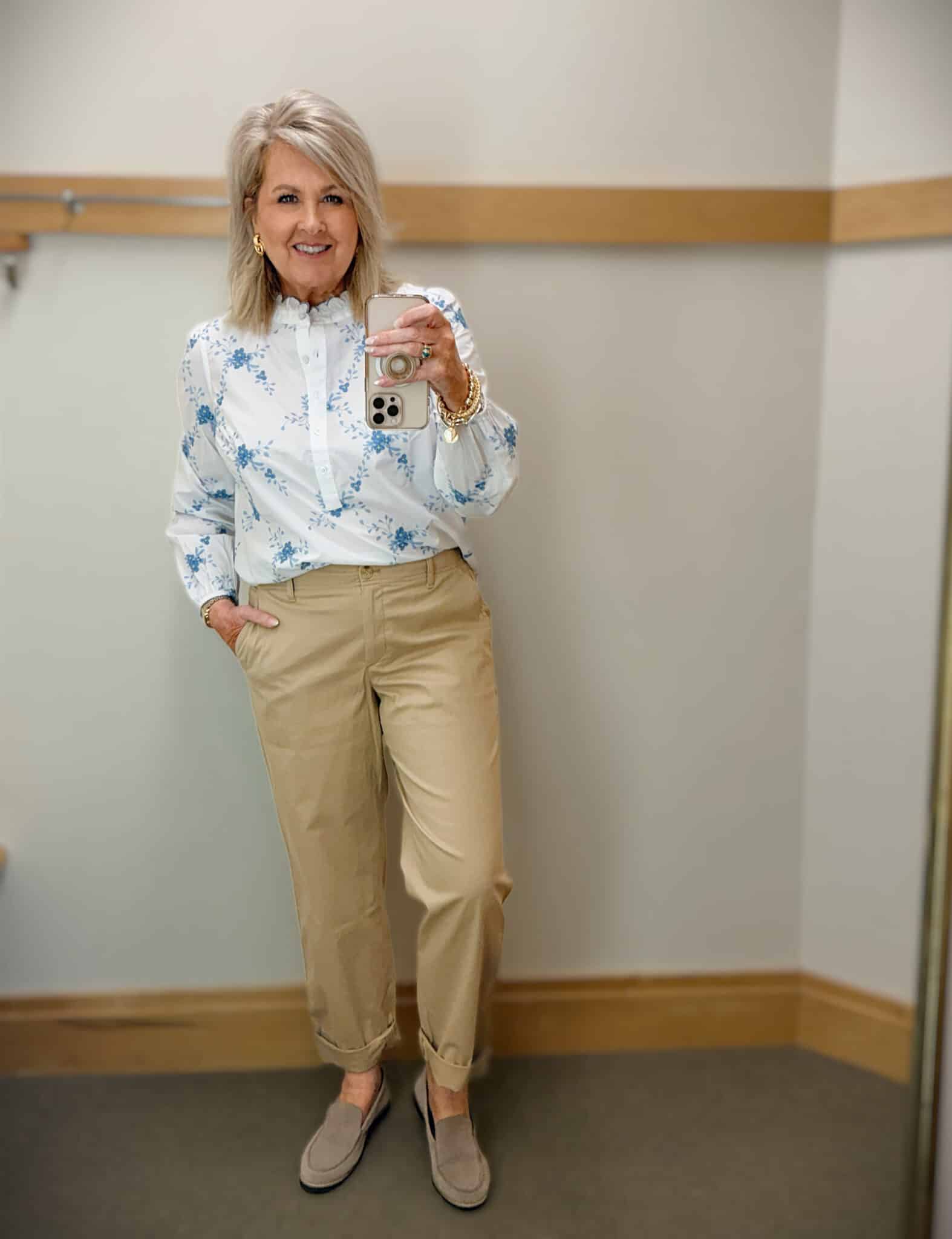 woman over 50 wearing embroidered floral top with twill chinos casual spring outfit