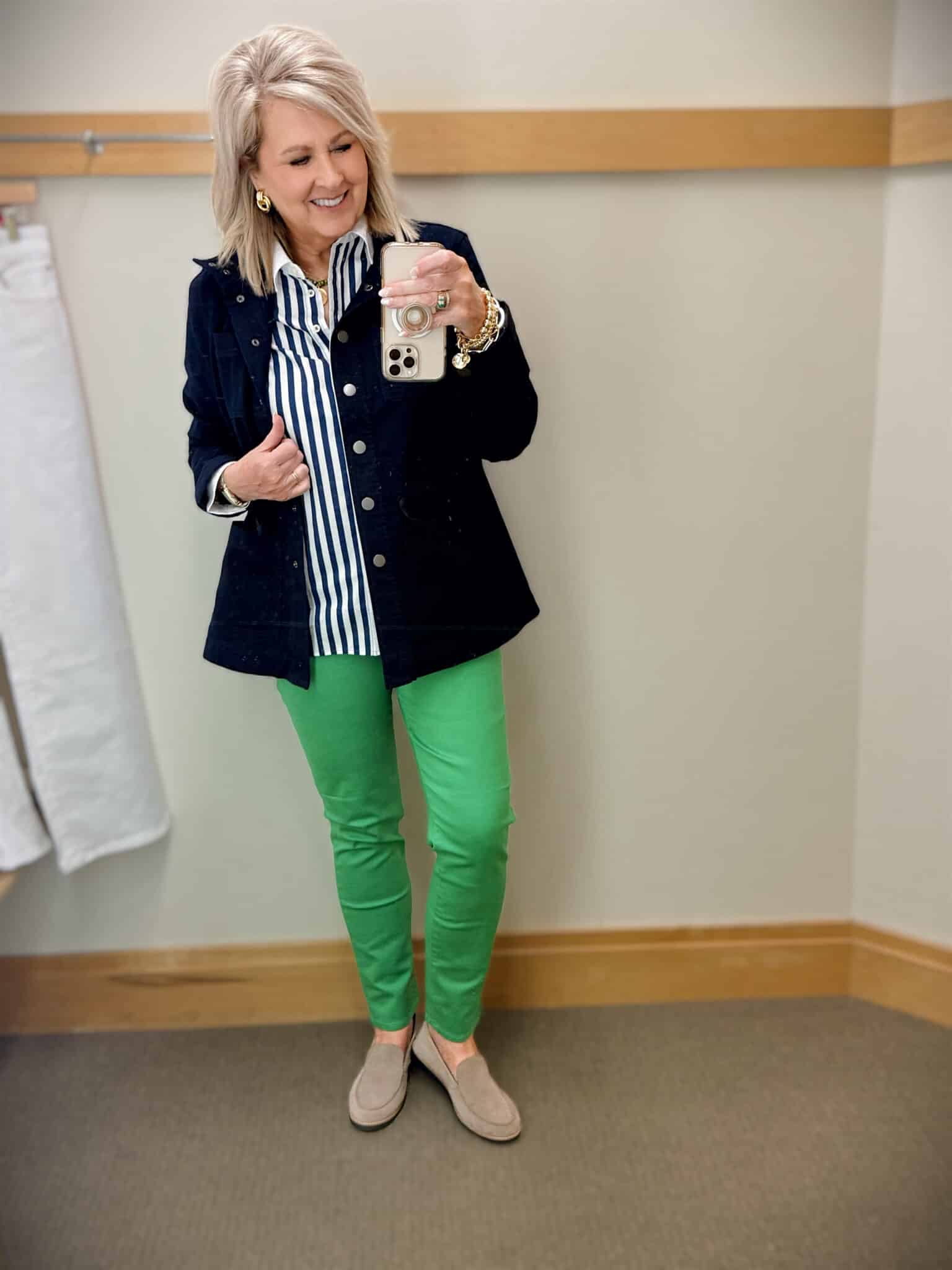 Tania wearing a striped shirt with a navy jacket and green slim jeans from Talbots