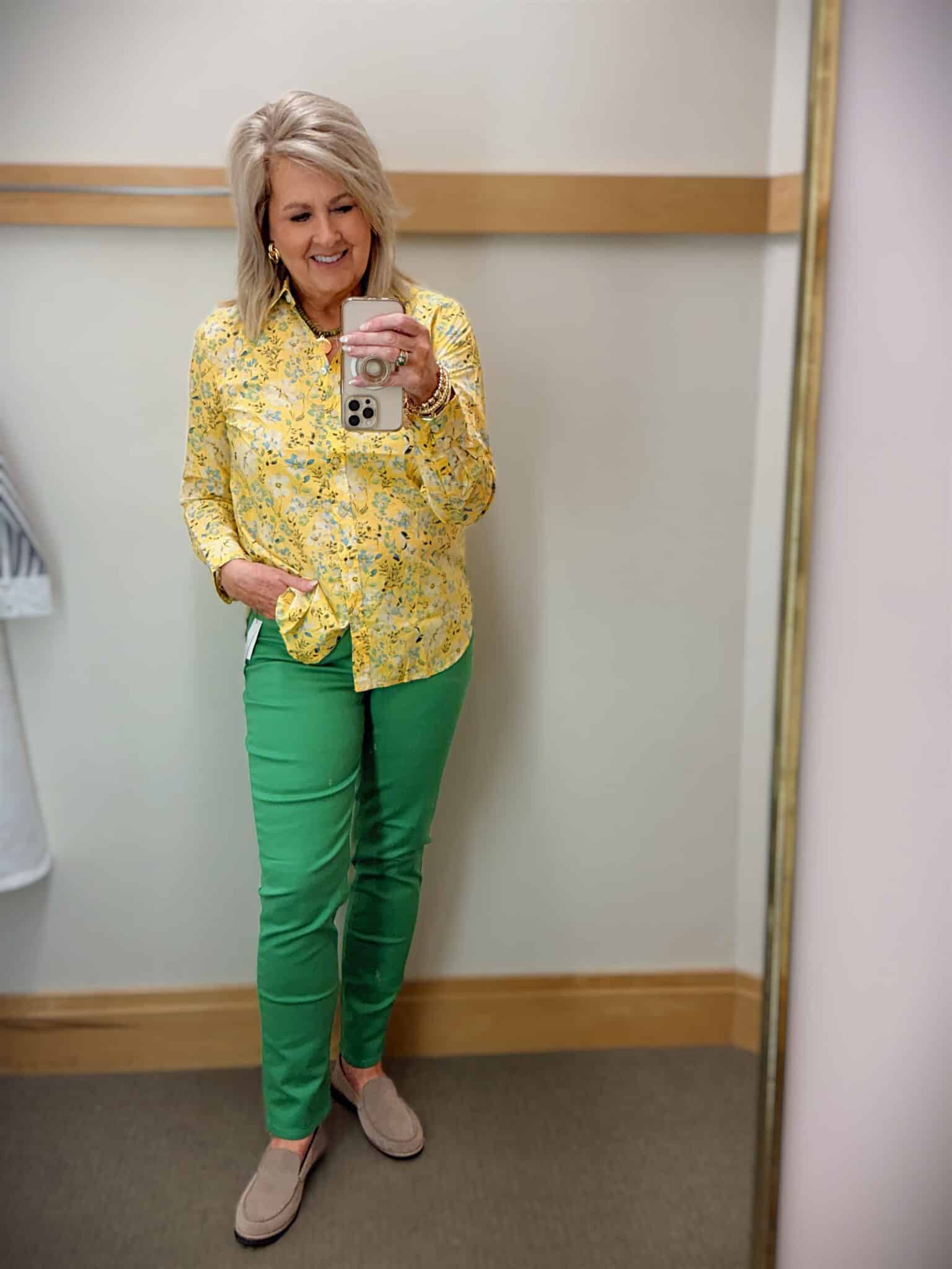 Tania wearing a yellow floral shirt and green slim jeans from Talbots
