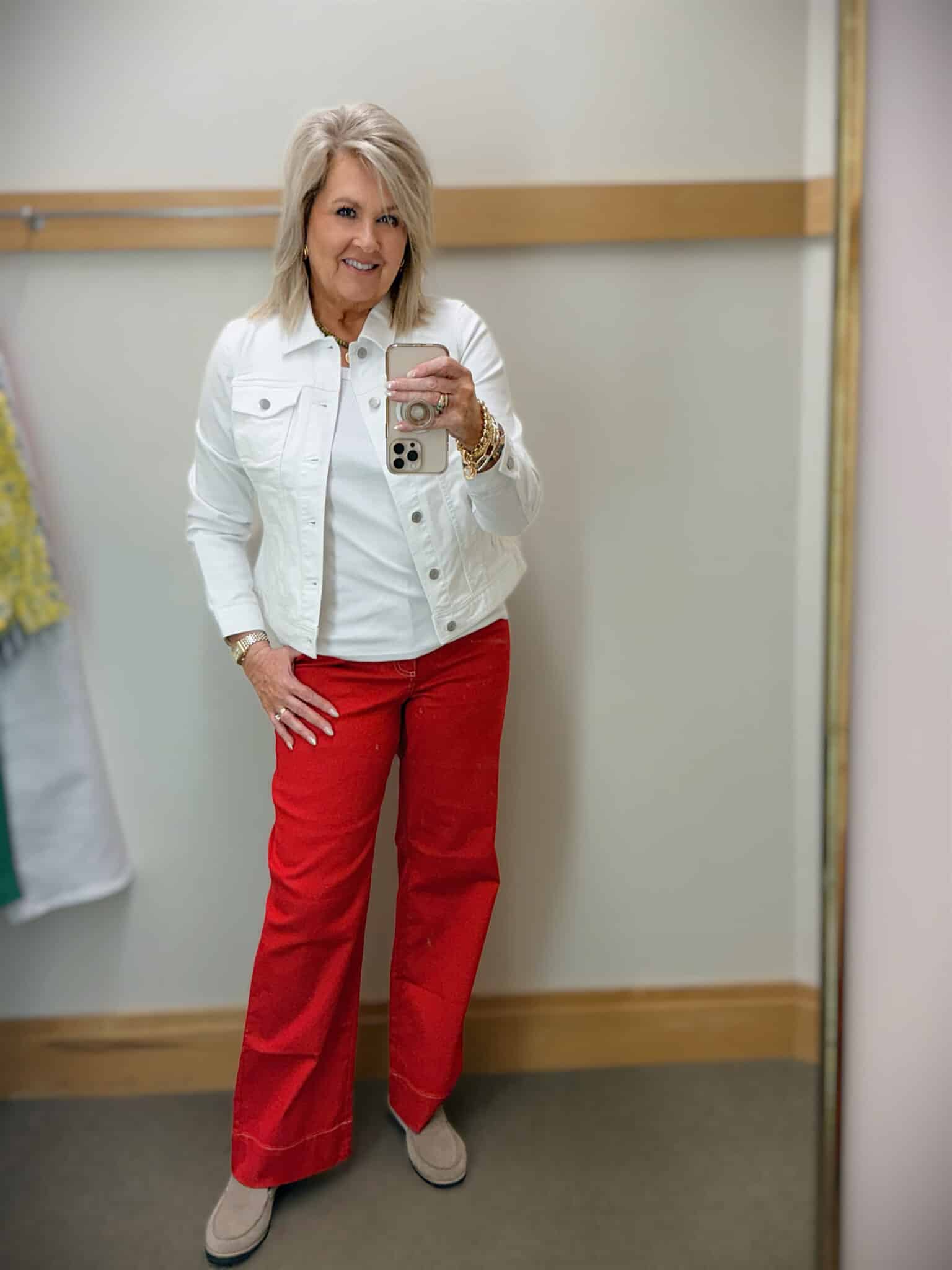 Tania wearing a white denim jacket with a white tank and red wide leg jeans from Talbots