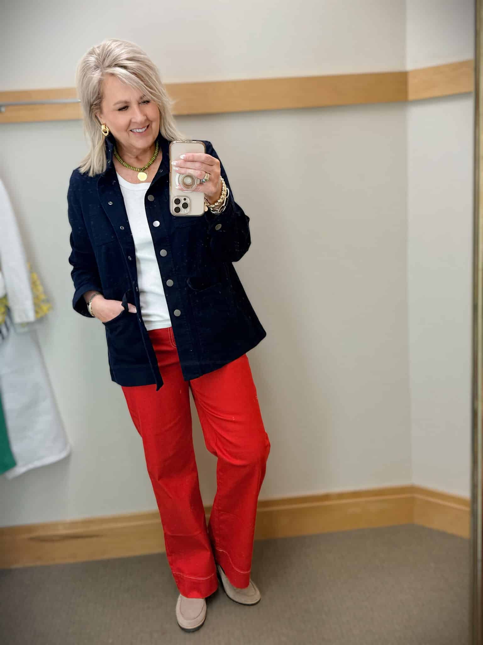 Tania wearing a white denim jacket with a white tank and a navy jacket, and red wide leg jeans from Talbots