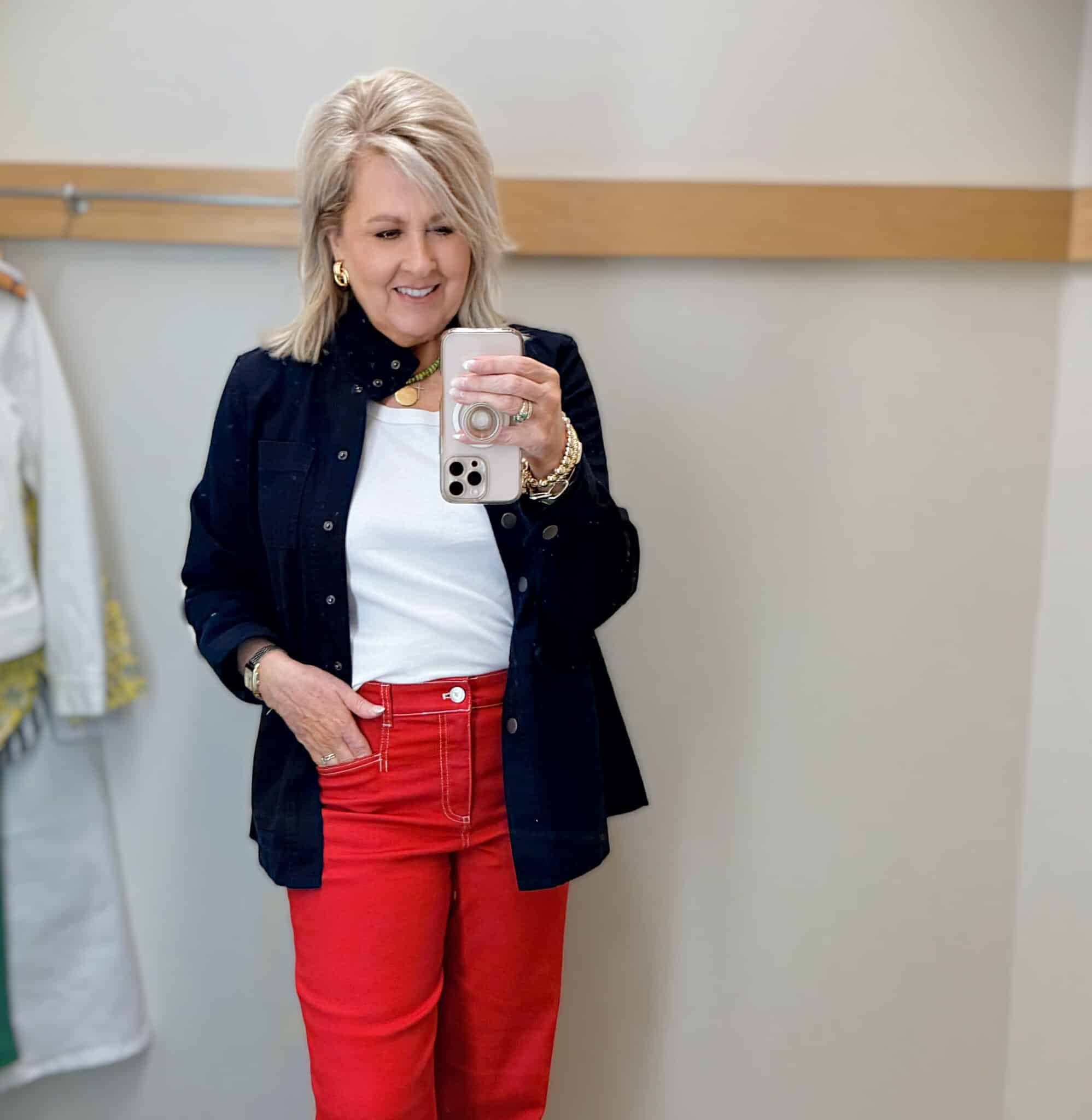 Tania wearing a white denim jacket with a white tank and navy jacket from Talbots