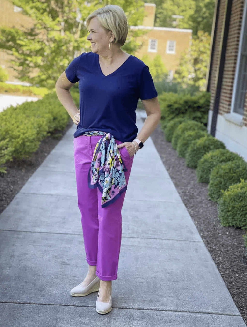 Tania wearing violet pants with a navy top and scarf